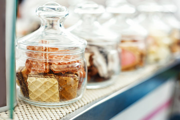 Sweet dessert street food festival. Cookies, waffles, pastries in a glass jar