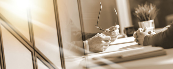Business negotiation between businesswoman and businessman; multiple exposure