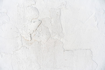 background cracked white wall. White plaster cracked. Cracks on the white wall. Grid on a white plaster wall texture.