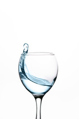splash of water in wineglass isolated on white background.