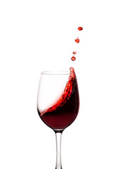 splash of red wine in glass isolated on white background.