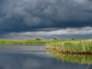 storm clouds over the lake with reeds