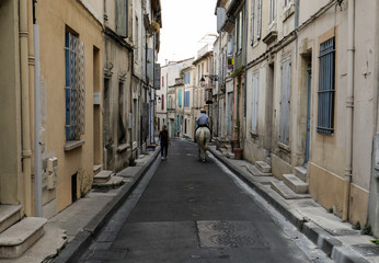  Rider on white horse in the old town of Arles in Provence. France.