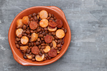 beans with smoked sausages and sausages in ceramic dish