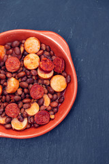 beans with smoked sausages and sausages in ceramic dish