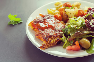 Fish fillet baked with cheese with potatoes, sweet potatoes, carrots and greens and vegetables mix. Fresh Salt dressing seasoned and sprinkled with sesame