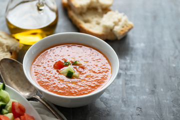 typical spanish cold spup gazpacho in white bowl on cermic background
