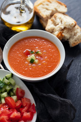typical spanish cold spup gazpacho in white bowl on cermic background