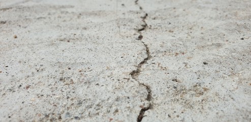 Fototapeta na wymiar Crack in concrete. Cracked foundation. Cracked road.