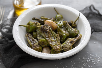 typical spanish food grilled green pepper with salt on dish