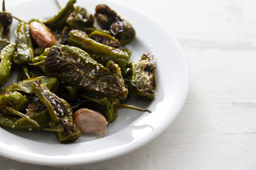 typical spanish food grilled green pepper with salt on dish