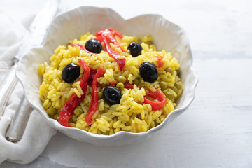 rice with vegetables and black olives in beautiful dish