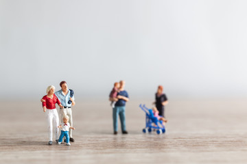 Naklejka premium Miniature people : Parents with children walking outdoor , Happy family concept