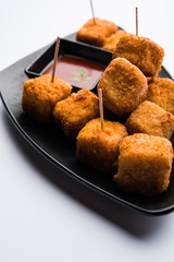 Crispy Paneer popcorn is a popular party snack and an appetiser. selective focus