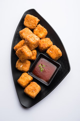 Crispy Paneer popcorn is a popular party snack and an appetiser. selective focus