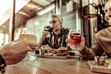 Close up of male hands that holding glasses