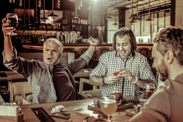 Positive delighted young man going to take picture