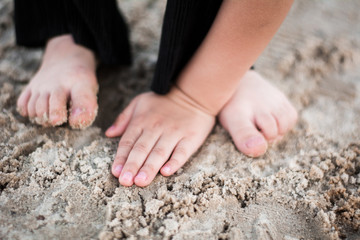 child legs flip flops shoes hat sand bling suit glasses child's hand