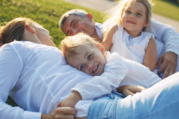 Family in nature. Parents with children have fun playing. 