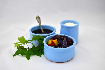 blue cup with fruit and berries, blue cup with sugar, blue cup with syrup
