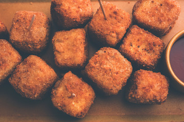 Crispy Paneer popcorn is a popular party snack and an appetiser. selective focus