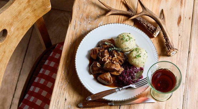 Serving of wild venison goulash and dumplings