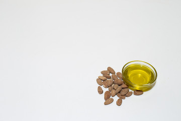 Almond oil as food ingredient in glass bowl – Natural organic nutrition supplement on white background with copy space