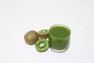 Glass of green smoothie next to kiwi fruits – Diet tropical juice on simple white background –...