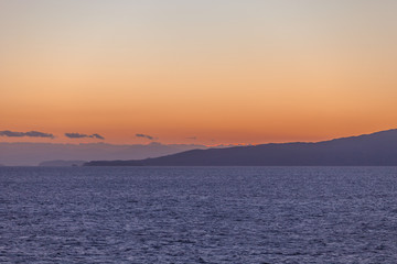 Partially cloudy sky at sunset over the islands of the Saronic Gulf