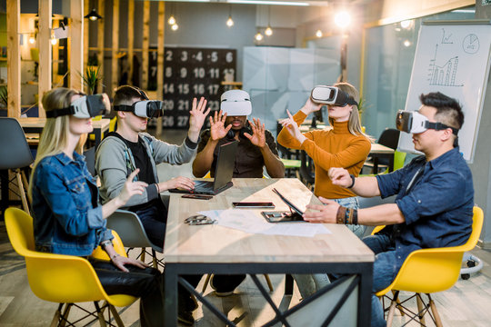 Five diverse business persons are developing a project using virtual reality goggles. the concept of technologies of the future - Powered by Adobe
