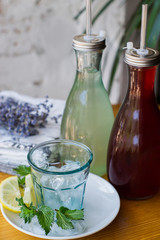Fresh homemade lemonade in a bottle on the table. Rustic Style.