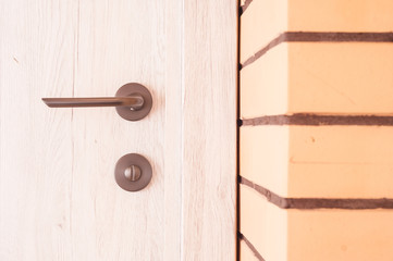 Interior with a combination of white wooden doors and beige decorative bricks