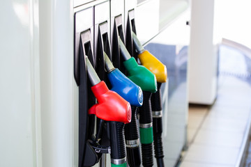 Gas pump nozzles in service station. Colorful Petrol pump filling nozzles, Gas station in a service.