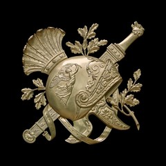 Golden decorative element of the interior with the image of the helmet from the ancient Greek myth....