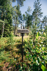 Wooden direction sign in Finland forest patch Kalliopolku