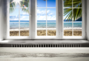 Fototapeta na wymiar Table background with a beautiful ocean sunny window view