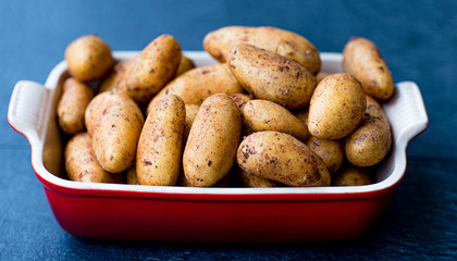 A new crop of potatoes lies in a baking dish.