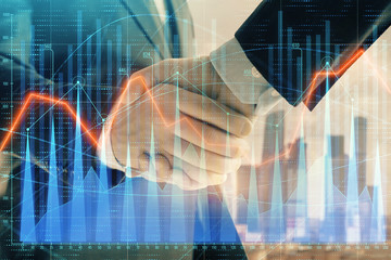 Double exposure of financial graph on cityscape background with two businessman handshake. Concept of stock market deal