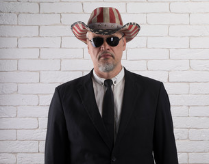 closeup portrait of an old gentleman, white brick wall