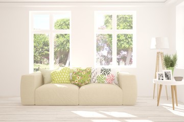 Stylish room in white color with sofa and summer landscape in window. Scandinavian interior design. 3D illustration