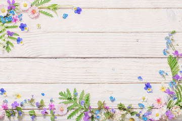 beautiful flowers on wooden background