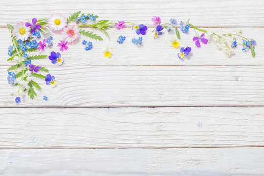 beautiful flowers on wooden background