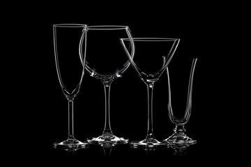 Glassware silhouettes on black.