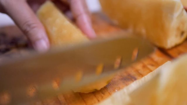 Sliced pineapple into pieces on the cutting board