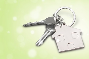 Silver Home key with badge on wooden