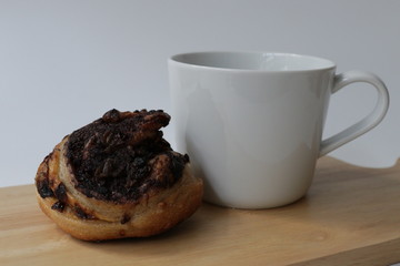 Cinnamon Bun with a Cup of Coffee