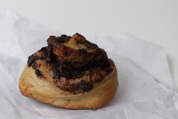 Close up Chestnut Cinnamon Bun on White Plate, White Background