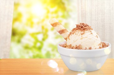 Ice cream scoops with vanilla, chocolate and berry scoops and topping