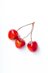 Top view image of bucnhes of fresh ripe red cherries isolated on white background