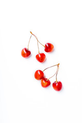 Obraz na płótnie Canvas Top view image of bucnhes of fresh ripe red cherries isolated on white background